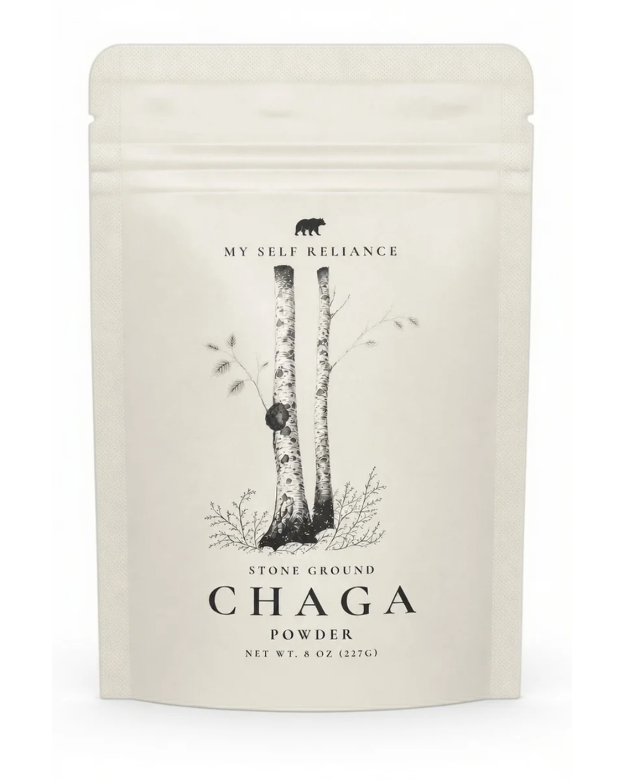 A 6 oz stand-up pouch of My Self Reliance Stone Ground Chaga Powder, featuring a minimalist black and white illustration of birch trees on a warm off-white background.